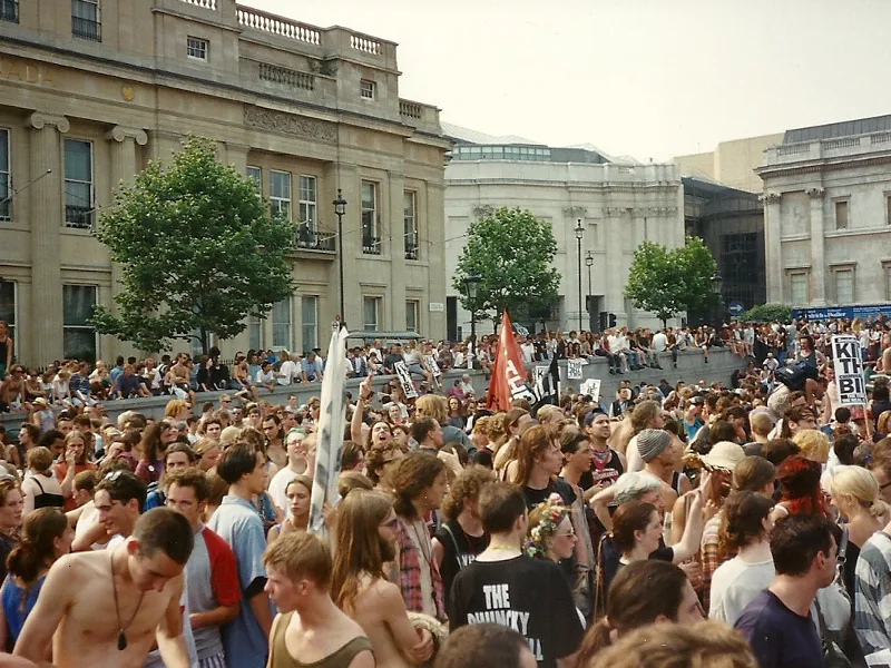 A dense crowd in Trafalgar Square with banners and placards during the march against the Criminal Justice Bill