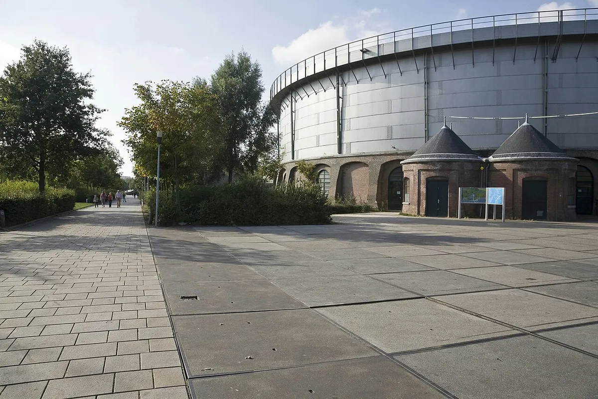 The round iron gasholder of the Westergasfabriek in Amsterdam, seen from the park