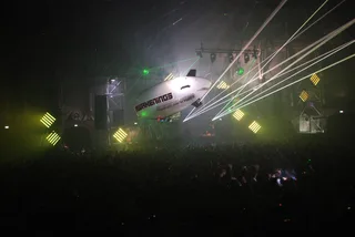 Awakenings' branded airship over the crowd with laser beams crossing the night sky