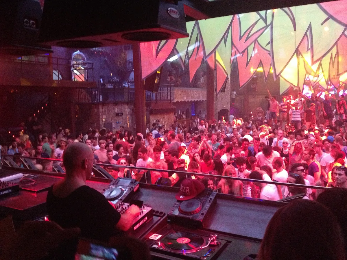 Sven Väth at the decks at Amnesia in Ibiza with the crowd in front of the booth