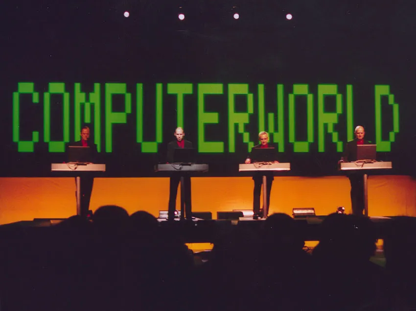 Kraftwerk on stage in Stockholm behind a row of illuminated consoles