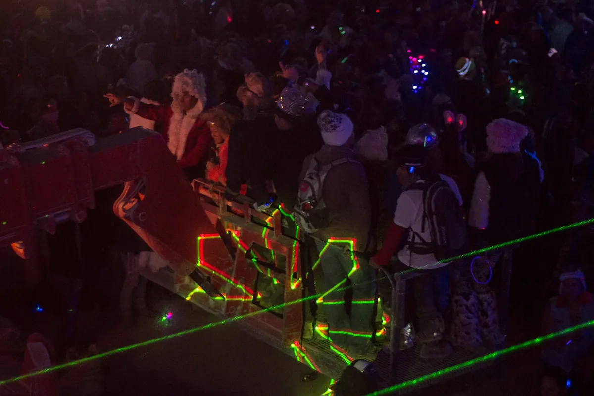 The Robot Heart art car on the playa at Burning Man, a bus crowned with a large illuminated heart