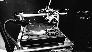 A vinyl cutting lathe with an acetate disc on the platter