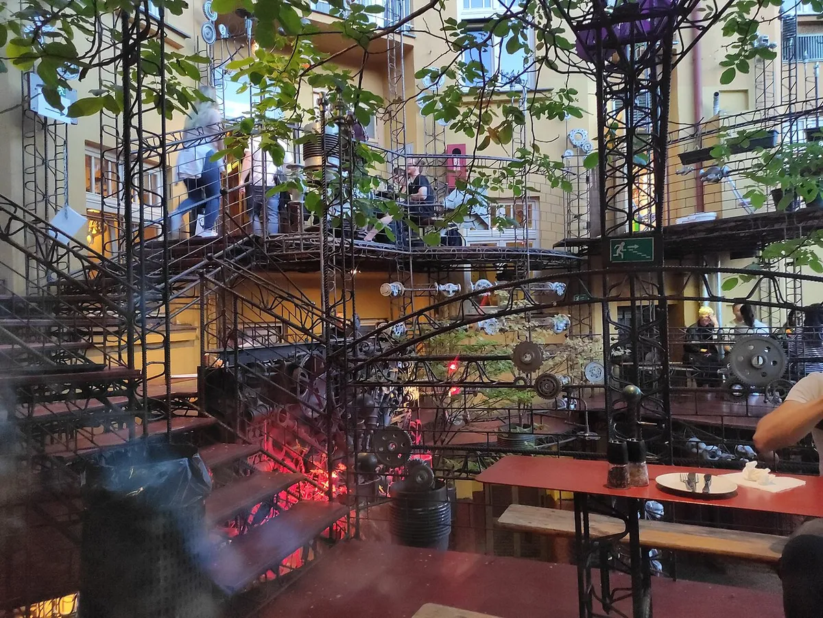 The courtyard of Cross Club in Prague, built from salvaged metal, pipes and machine parts