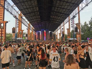 A daytime crowd under the steel canopy of the Futur Stage at Kappa FuturFestival in Turin