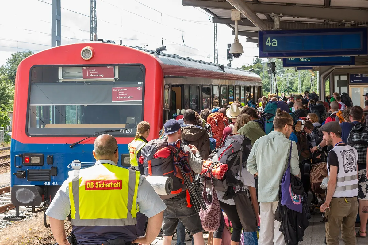 Festival-goers boarding a regional railcar at Neustrelitz station on the way to Fusion Festival in 2016