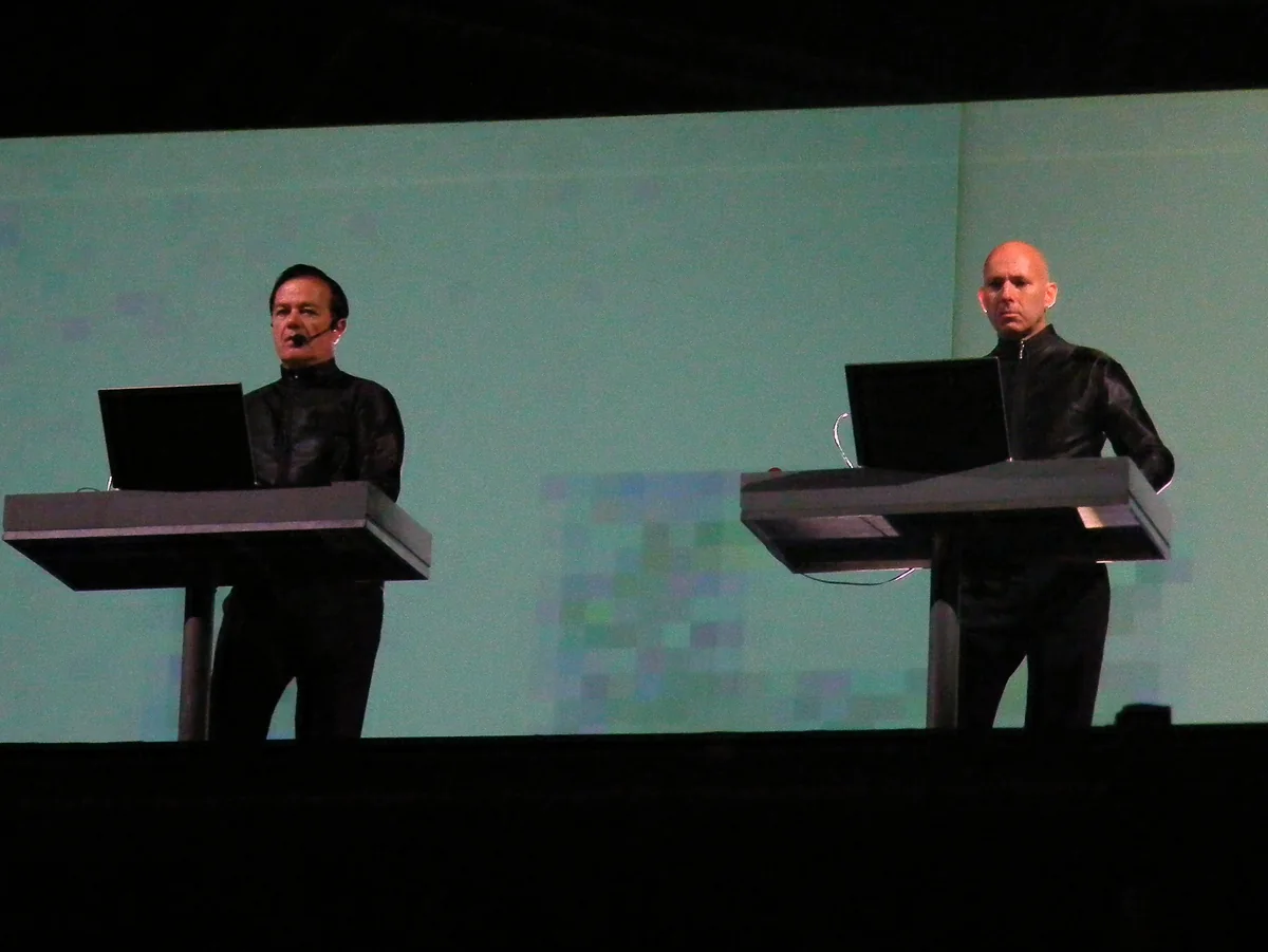 Ralf Hütter and Henning Schmitz of Kraftwerk performing behind electronic consoles at Bestival in 2009