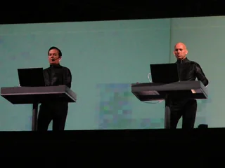 Kraftwerk performing behind electronic consoles
