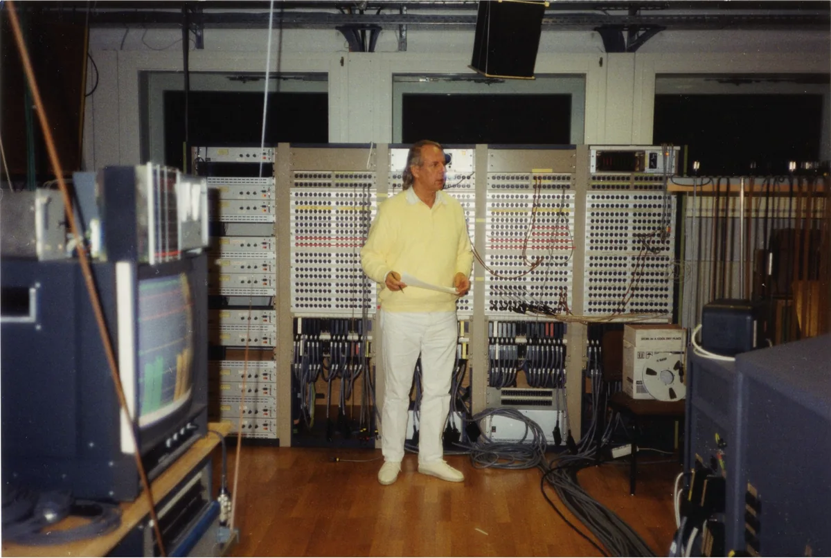 Karlheinz Stockhausen standing among electronic equipment in the WDR Studio in Cologne in 1991