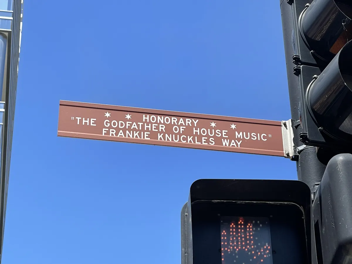 A brown Chicago street sign reading Honorary The Godfather of House Music Frankie Knuckles Way
