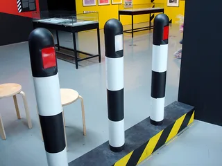 Three of the Haçienda's surviving hazard-stripe bollards, on display in 2007