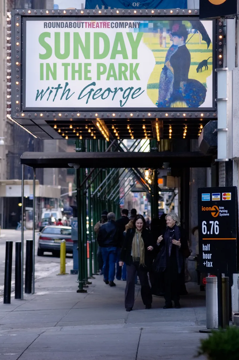 The marquee and doors of the Studio 54 theatre on West 54th Street at night