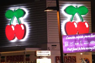 The red cherry signs of Pacha Ibiza lit at night