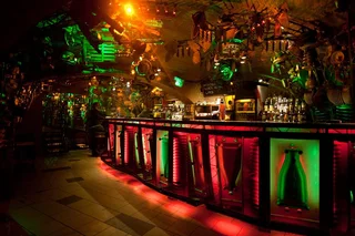 The interior of Cross Club's basement bar in Prague, built from salvaged metal and machine parts