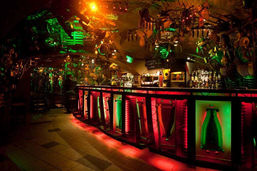 The interior of Cross Club's basement bar in Prague, built from salvaged metal and machine parts
