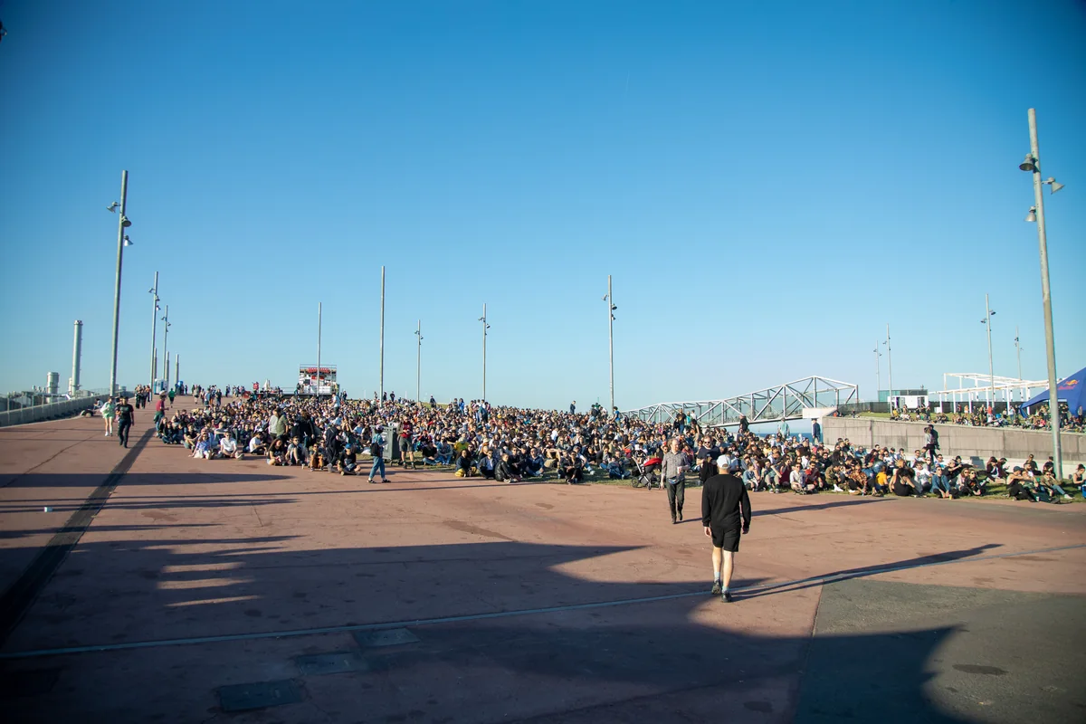 Festivalgoers gathered beside the waterfront at Primavera Sound Barcelona in 2019 under a clear blue sky