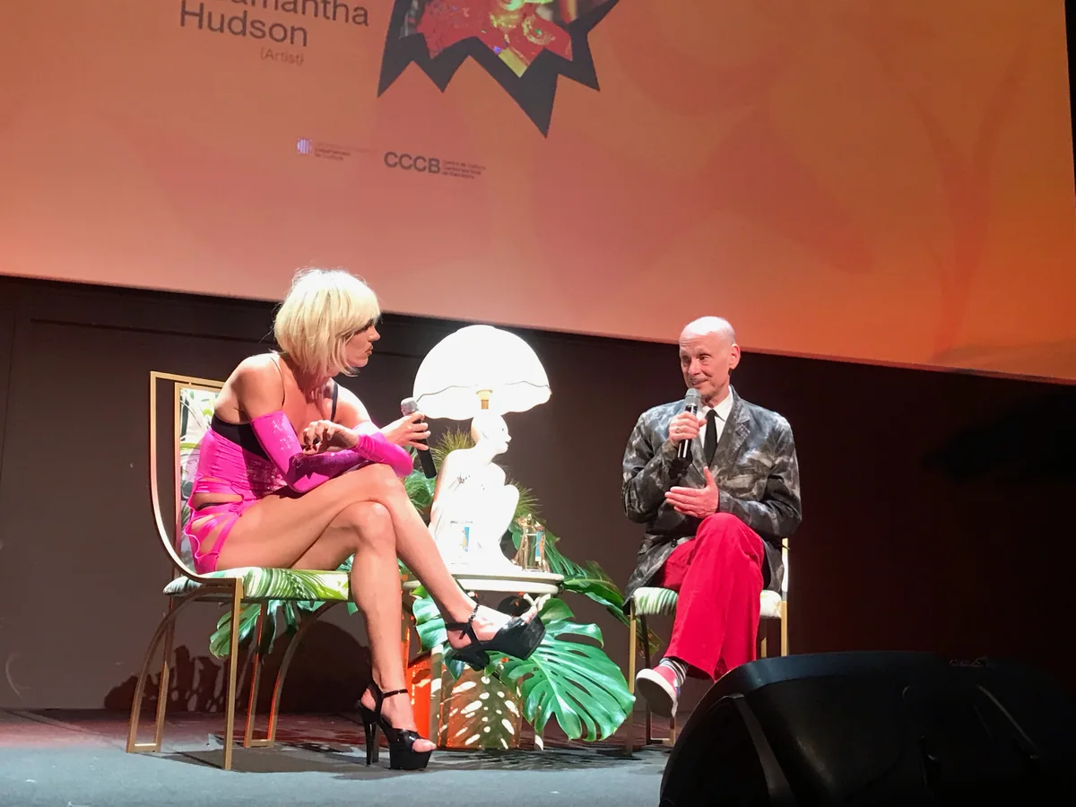Samantha Hudson and John Waters seated on stage in conversation at Primavera Pro in 2022
