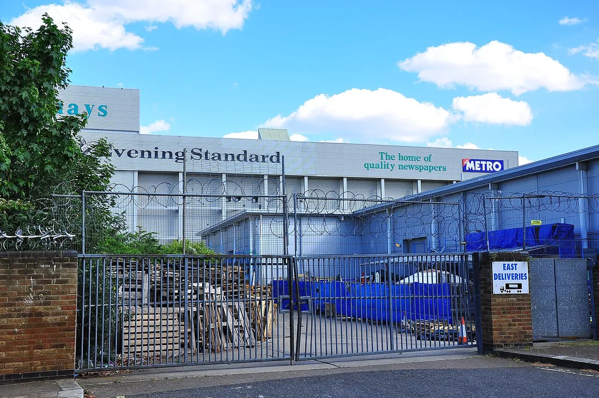 A fenced gate with barbed wire and an East Deliveries sign at the Harmsworth Quays print works in Rotherhithe