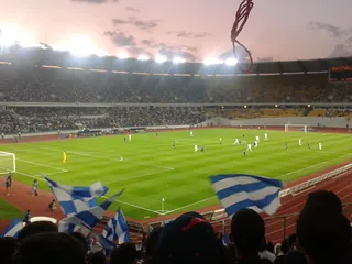 The Boris Paichadze Dinamo Arena in Tbilisi during a football match, with fans in the foreground