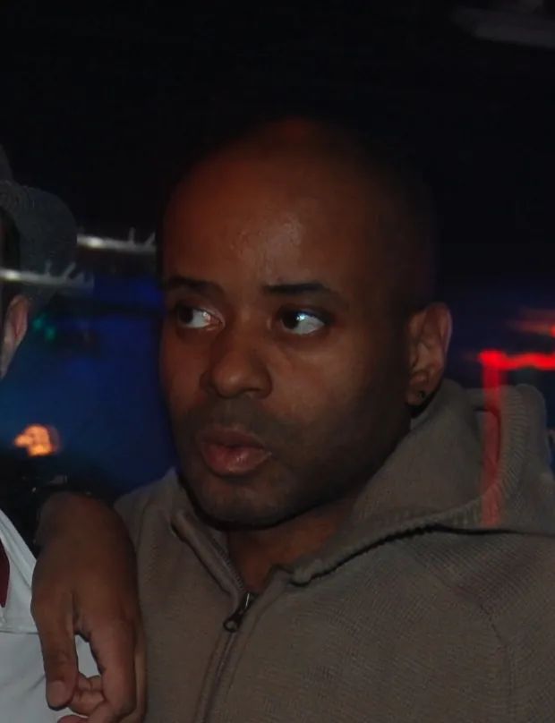 Juan Atkins in a grey hooded top in a dark club