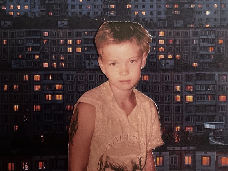 thecatrave as a child in front of an Eastern European apartment block