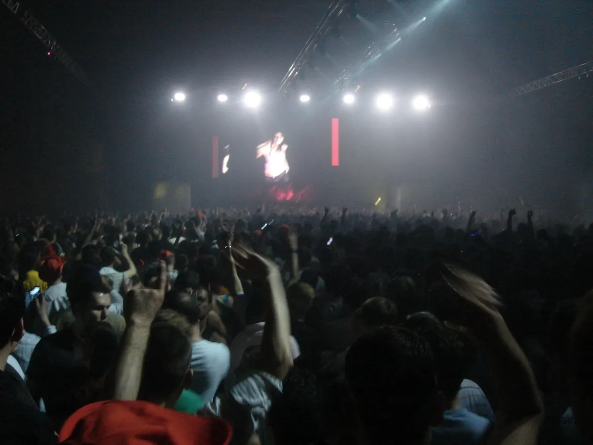 A packed dance floor facing a stage with video screens at Time Warp in 2006