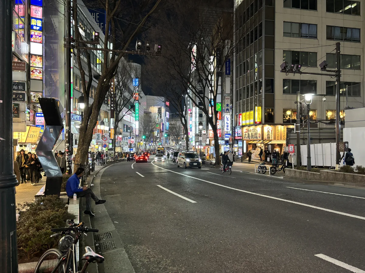 Dogenzaka at night, its steep street lined with illuminated signs for clubs, bars and karaoke boxes