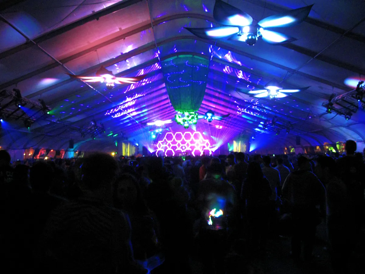 A DJ on the main stage at Beyond Wonderland in 2010, with a crowd below