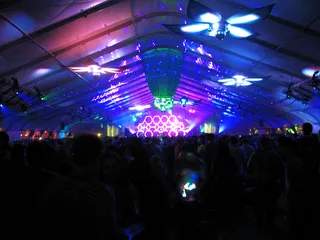 A DJ on the main stage at Beyond Wonderland in 2010 above a crowd