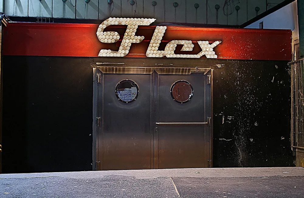 The lit Flex sign above the entrance to the club in Vienna at night