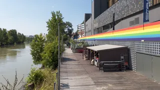 The Grelle Forelle building on the Spittelauer Lände by the Donaukanal in Vienna, with a rainbow stripe on its facade